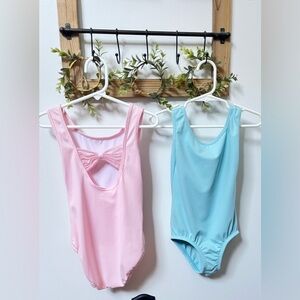 2 pieces: One pink & one blue ballet leotard in Size S (6-7 girls)